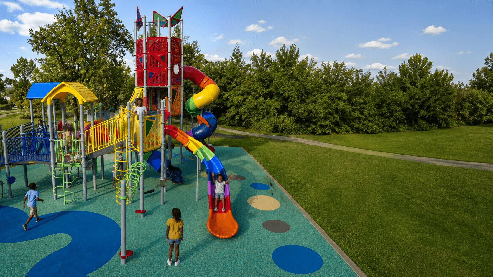 Children playing on a colorful LilyRose playground structure